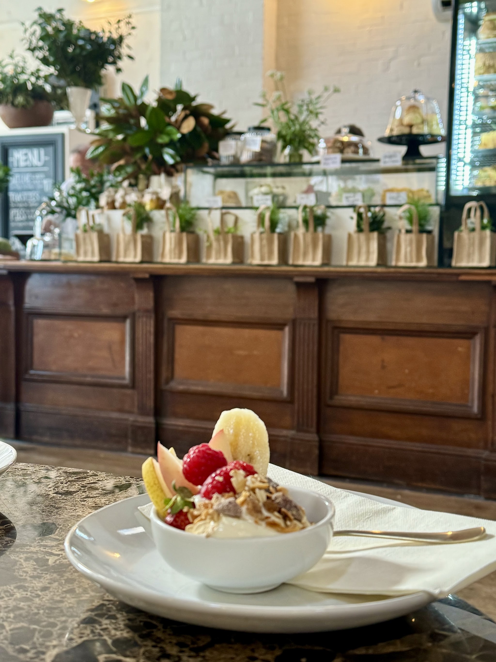 The original timber bank counter with the menu blackboard, cake cabinet and rows of kraft gift bags